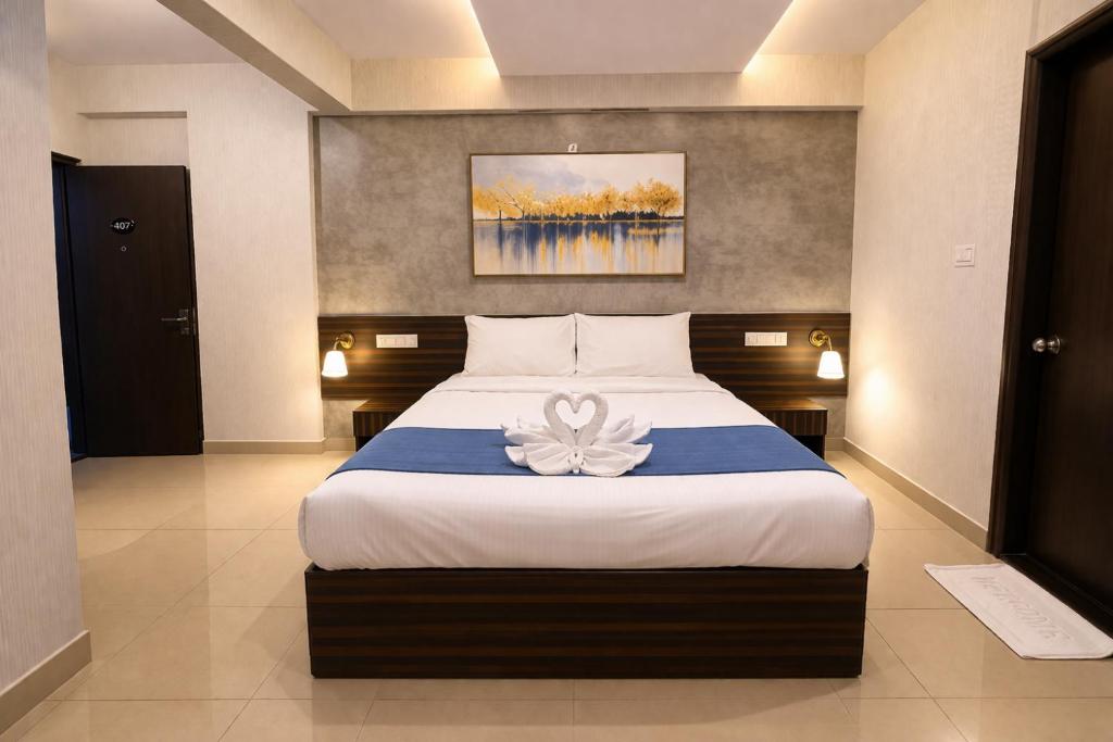 a bedroom with a large bed with a flower on it at Harvey's Brookefield-With Free Car Parking in Bangalore