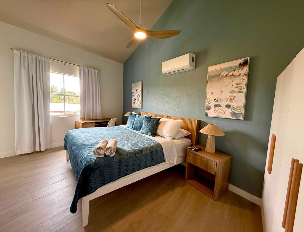 a bedroom with a bed with two shoes on it at Lantana Sea La Vie - by ZenBreak in Saint James