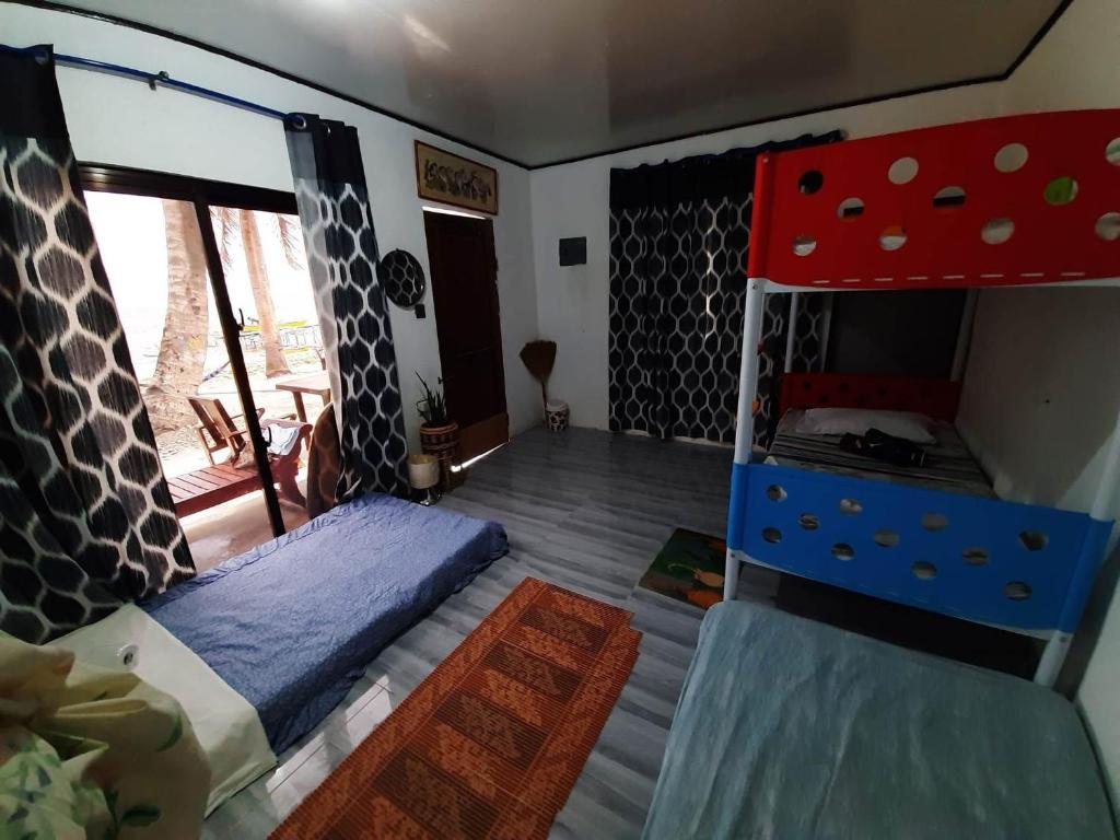 a bedroom with a bed and a bunk bed at INS n OUTZ in Bolinao
