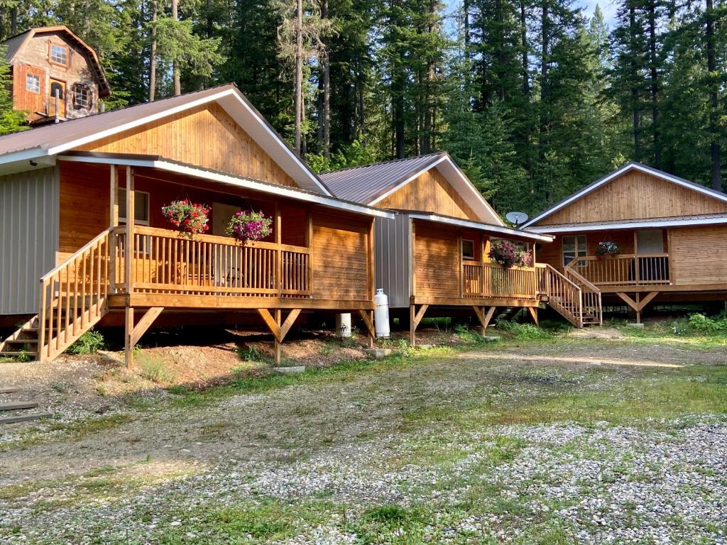 a large house with decks with flowers on them at Last Spike Lodging in Malakwa