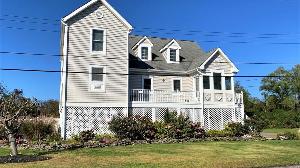 a large white house with a porch at 324 First Ave in West Cape May