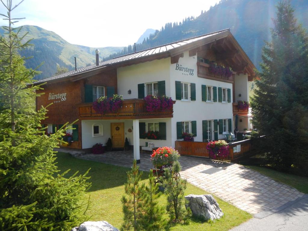 a house with flowers on the front of it at Das Bürstegg in Lech am Arlberg