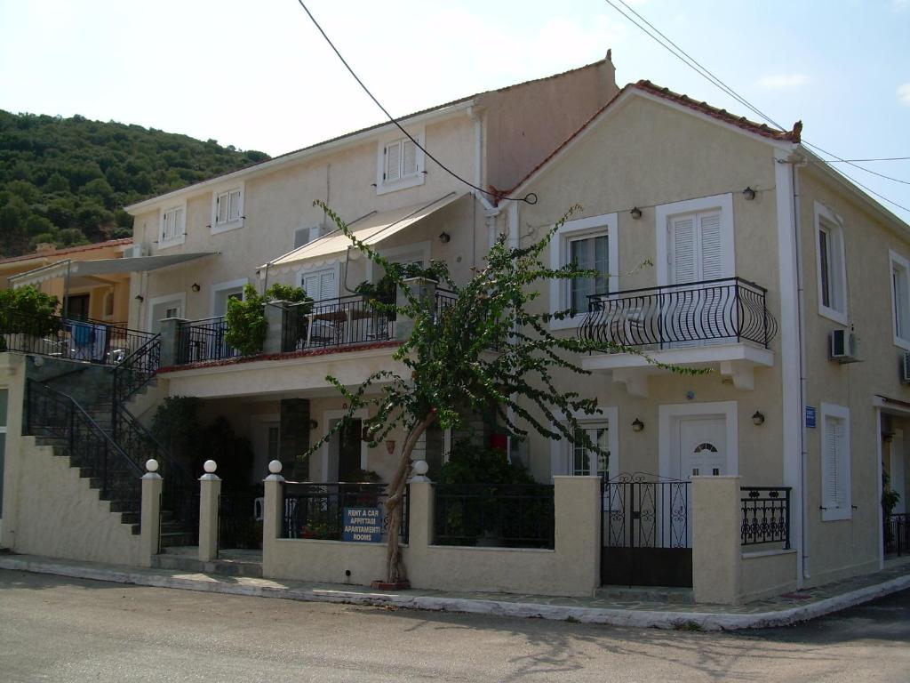 a large white house with balconies on the side of it at Starvillas Apartments and Studios in Ayia Evfimia