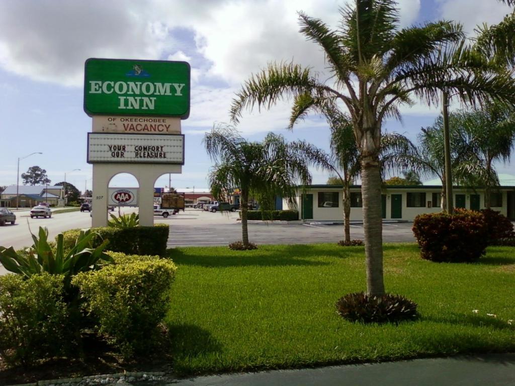 a sign for a goodwill inn in a parking lot at Economy Inn Okeechobee in Okeechobee