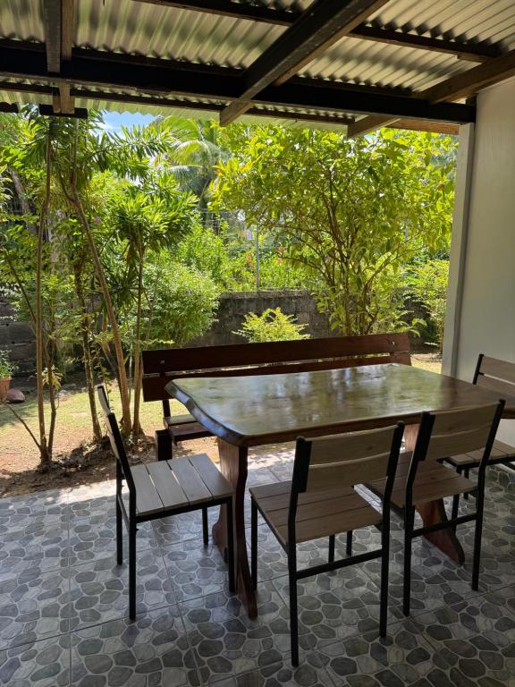 a wooden table and chairs on a patio at Studio VAI in HUH