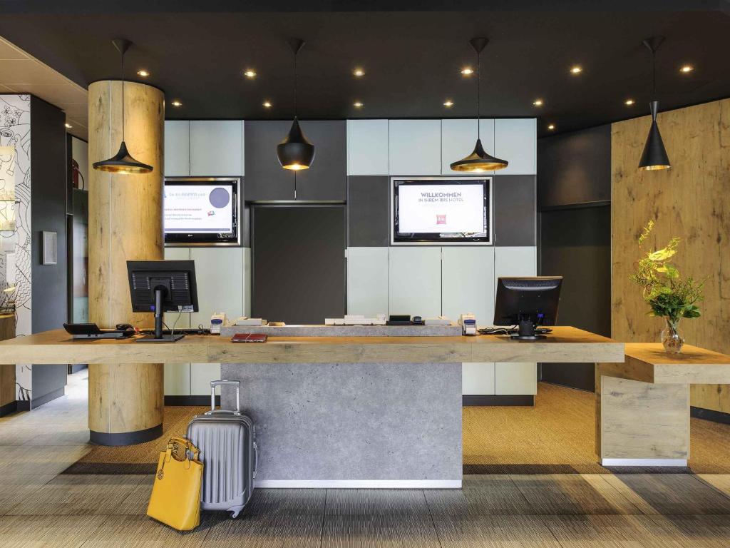 an office with a large desk with two computers at ibis Hotel Hannover City in Hannover