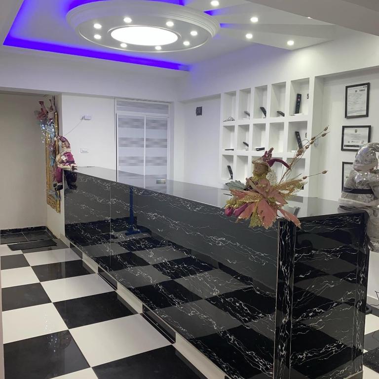 a lobby with a black and white checkered floor at Hotel Pacífico Azul in Bahía Solano