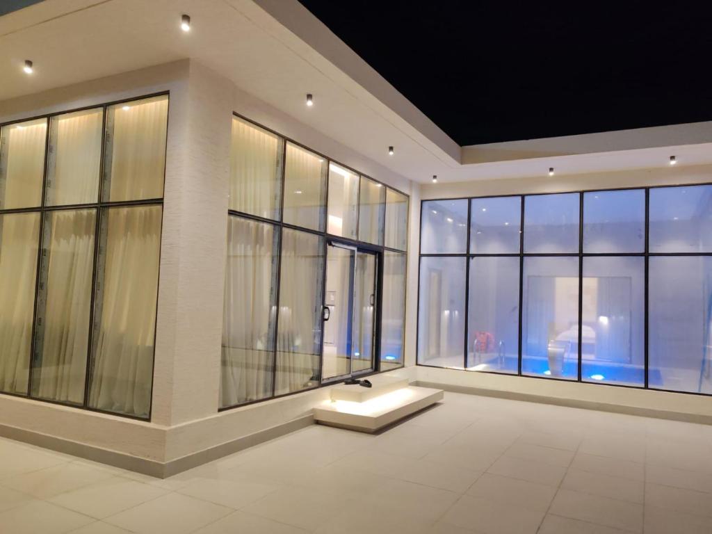 a large room with large windows with a view of the city at شاليه اغصان الباحة in Al Baha