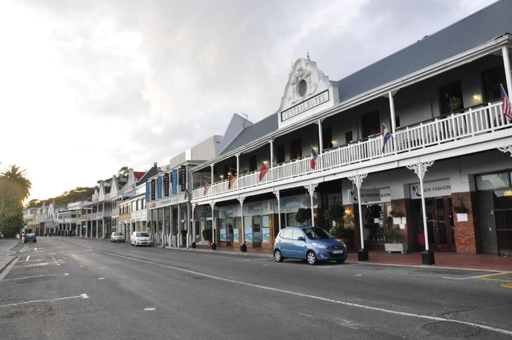 a blue car parked on the side of a street at Central Hotel Guest House in Simonʼs Town