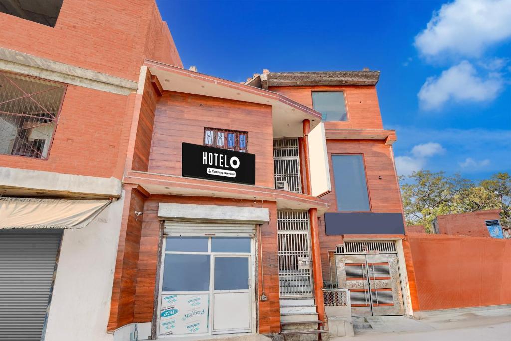 a brick building with a sign that reads trio at Super Hotel O Raj Ghat Ayodhya Formerly Shree Siya Raman in Ayodhya