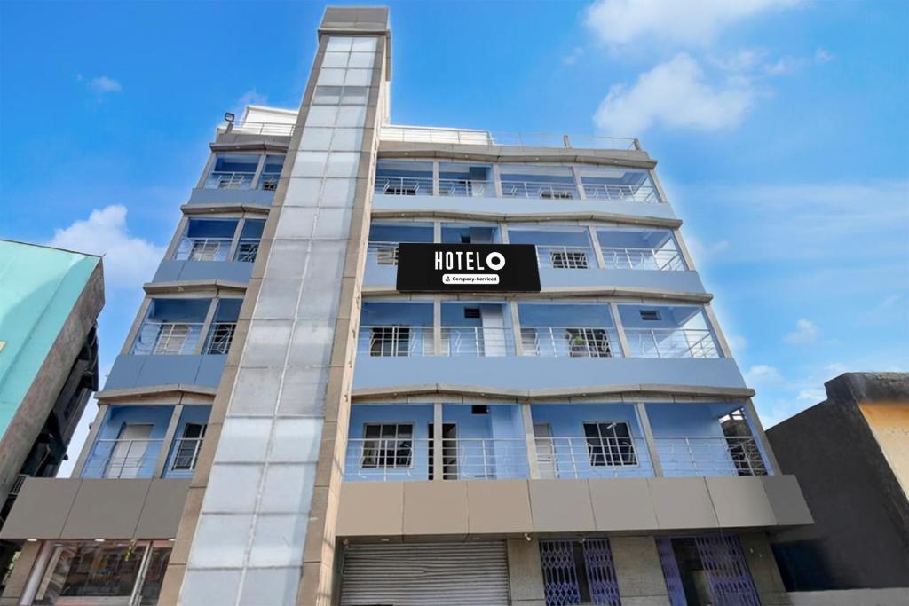 a tall building with a hotel sign on it at Hotel O Tarapith Temple Formerly Prerana 2 in Tarapith