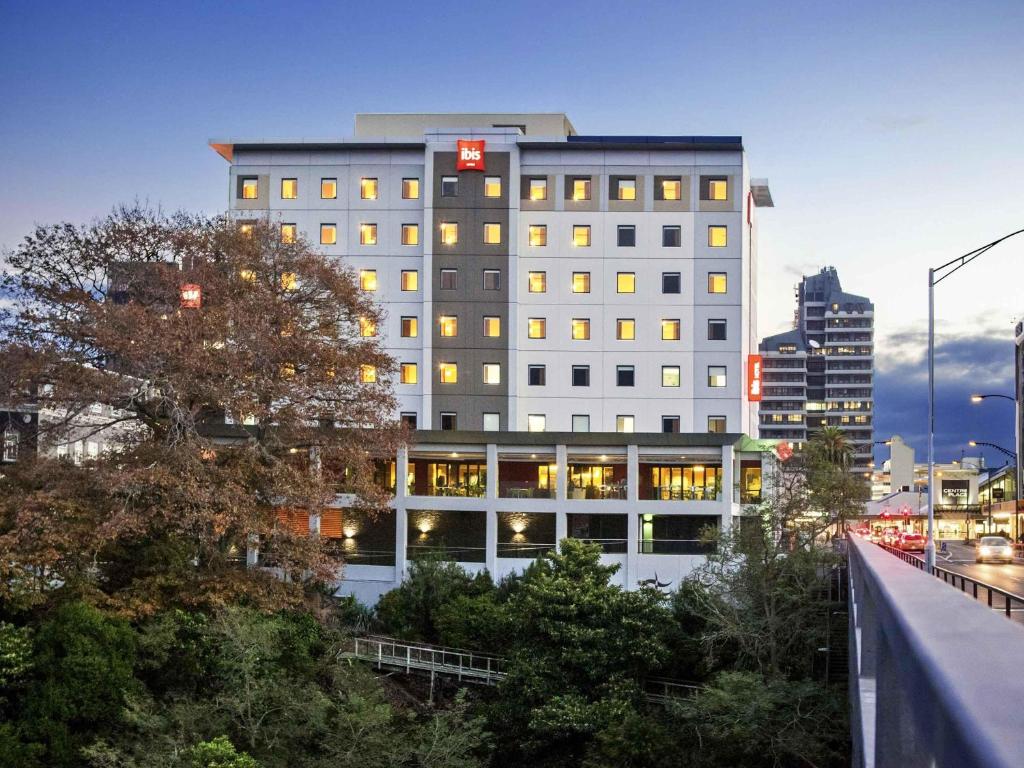a tall building with a sign on top of it at ibis Hamilton Tainui in Hamilton