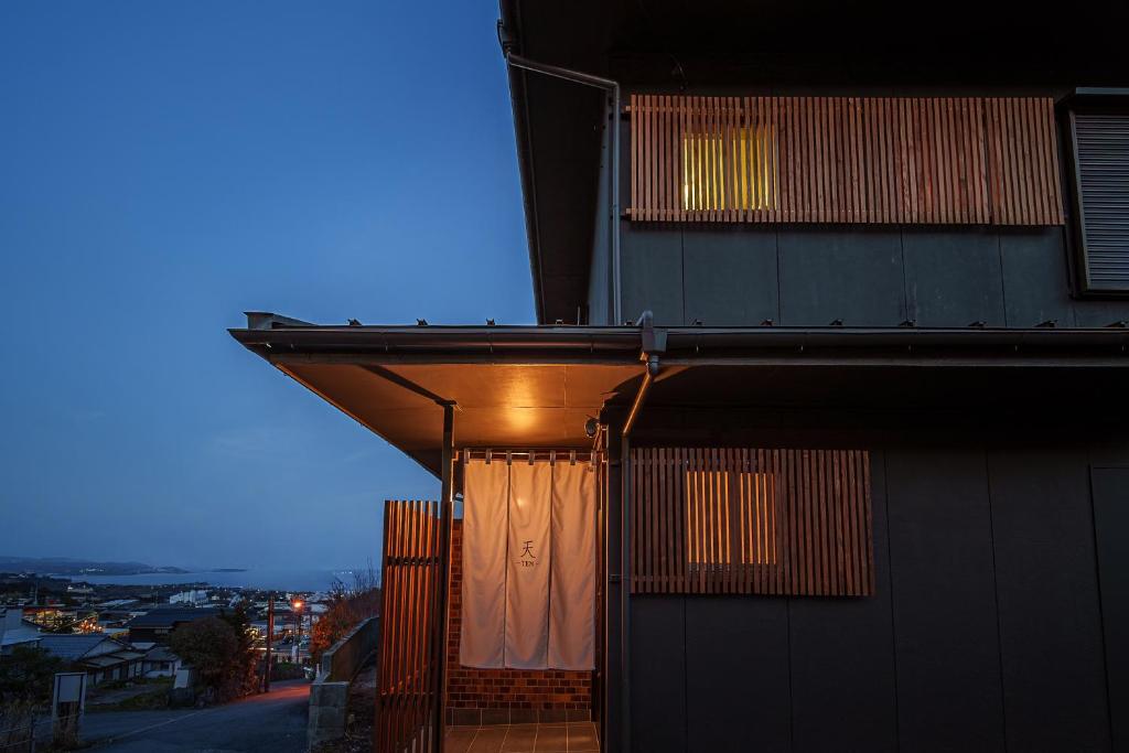 a building with a curtain on the side of it at 民泊-天- in Beppu