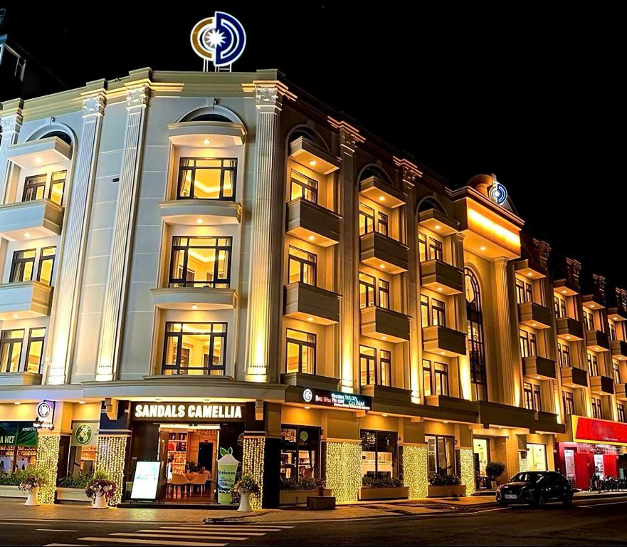 a large building with a clock on top of it at Sandals Camellia Hotel in Da Lat