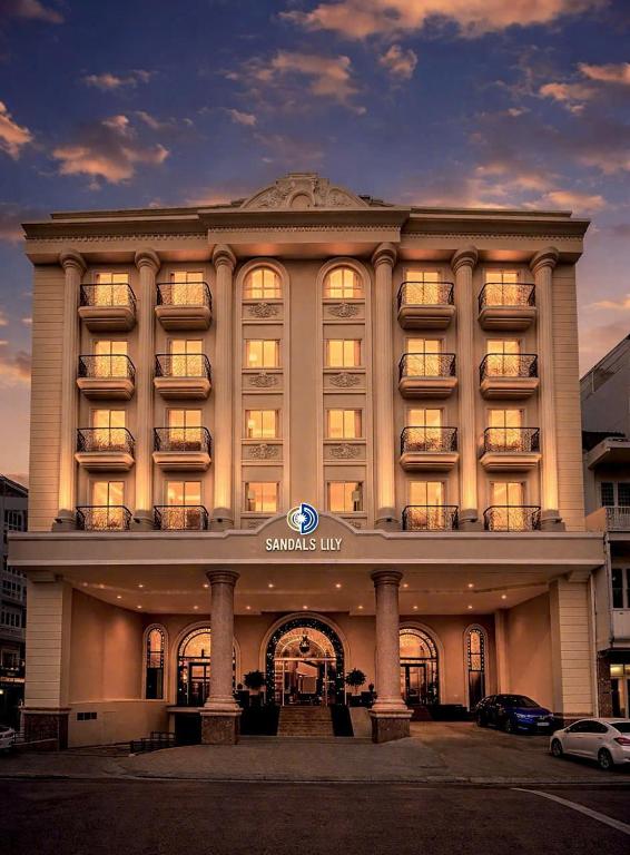 a large building with a sign on the front of it at Sandals Lily Hotel in Da Lat