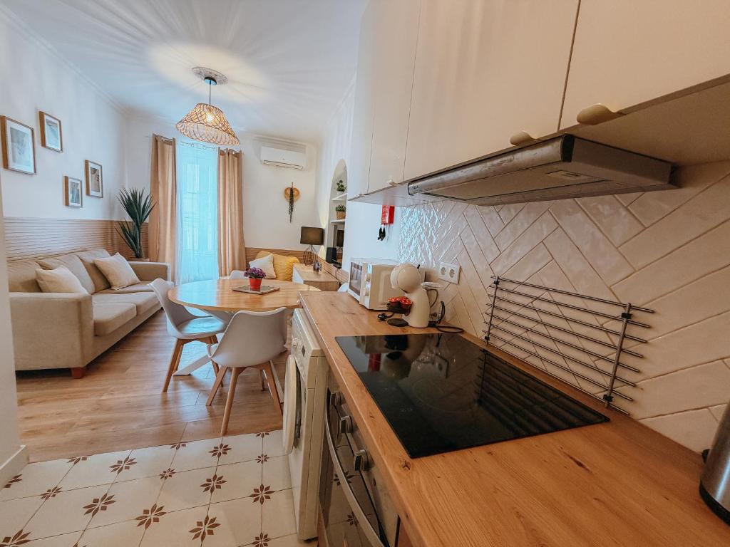 a kitchen and living room with a table and a couch at Sol e Rio in Setúbal