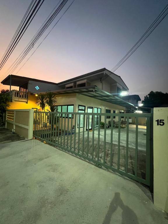 a building with a gate in front of it at TUK&TOON House in Sathani Ban Thap Chang