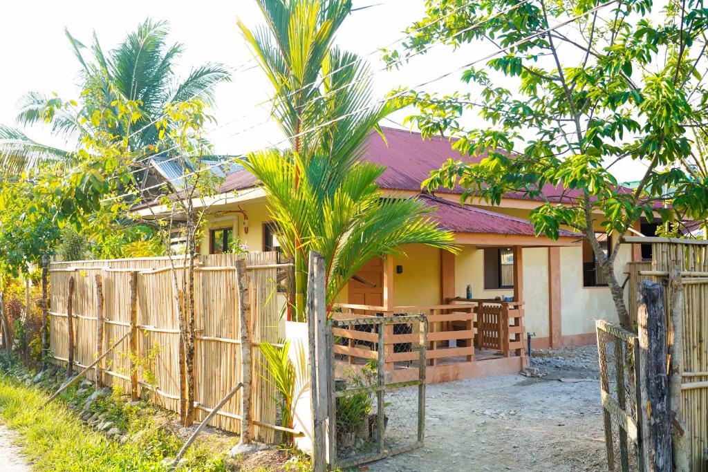 a house with a wooden fence in front of it at Aman House in San Vicente