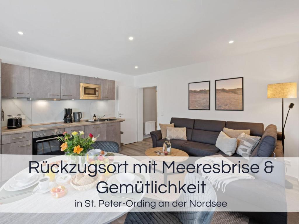 a living room with a couch and a kitchen at Entspannter Nordsee-Urlaub in naturnahen Ferienwohnungen im Haus Tide in Böhl