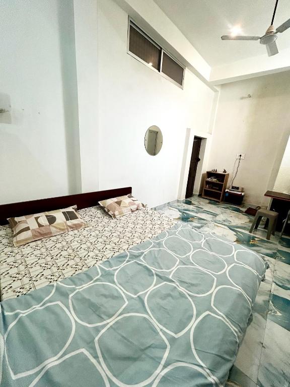 a bedroom with a large bed in a room at The Boho House in Darbhanga