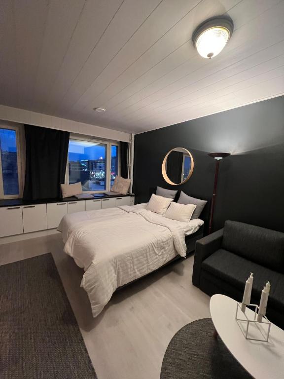 a bedroom with a large bed and a couch at Top location in Joensuu in Joensuu
