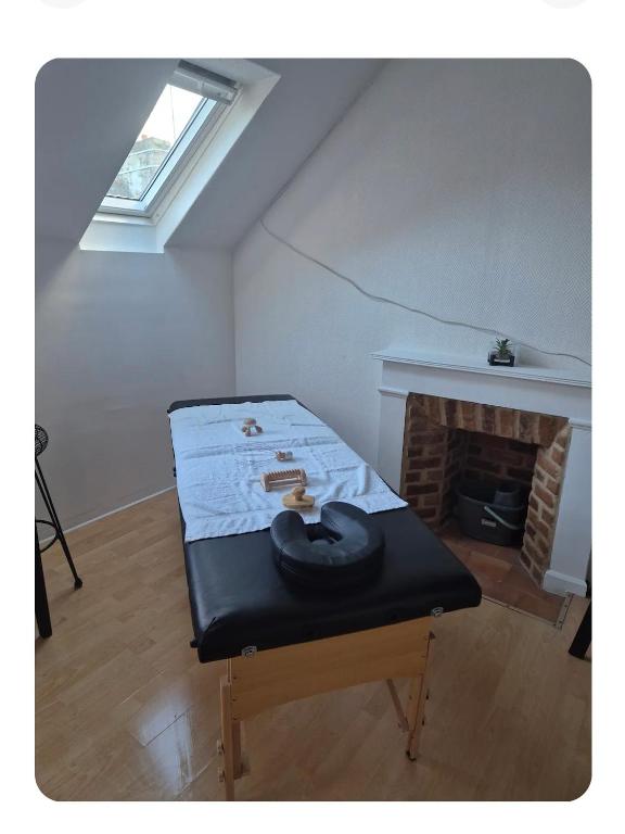 a mattress sitting in a room with a fireplace at Le petit duo in Saint-Brieuc