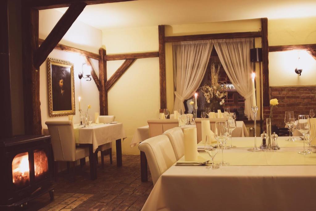 a dining room with white tables and white chairs at Barock Restaurant & Pension in Topoľčany