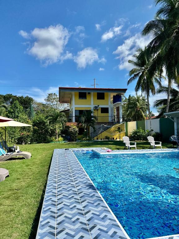 a swimming pool in front of a house at Villa Lourdes Resort in Panglao Island