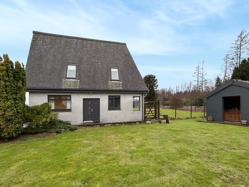 a house with a green yard with a house at The Annexe - Uk51362 in Dollar