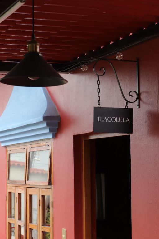 a sign hanging off the side of a building at Hacienda Casa de Piedra in Tlacolula de Matamoros