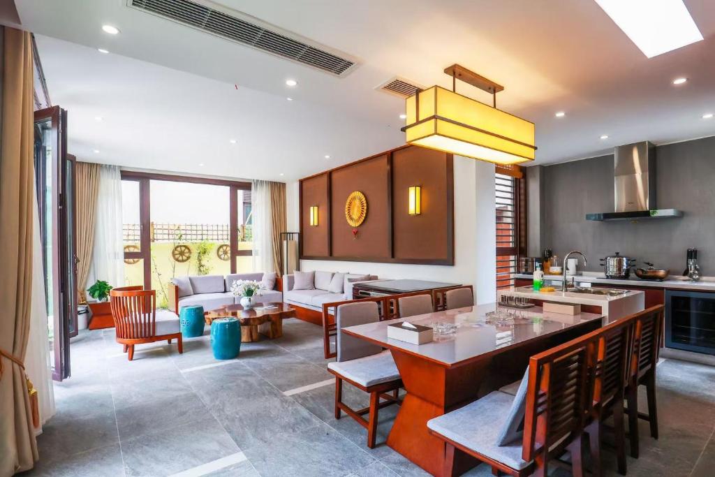 a kitchen and living room with a table and chairs at Book and Bed-ChongMing in Shanghai
