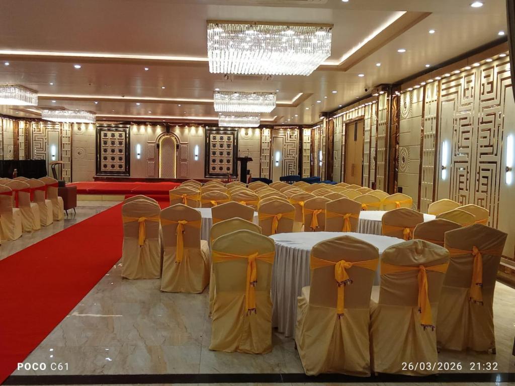 a banquet hall with tables and chairs in a room at Shreeja Central in Bhawānipatna