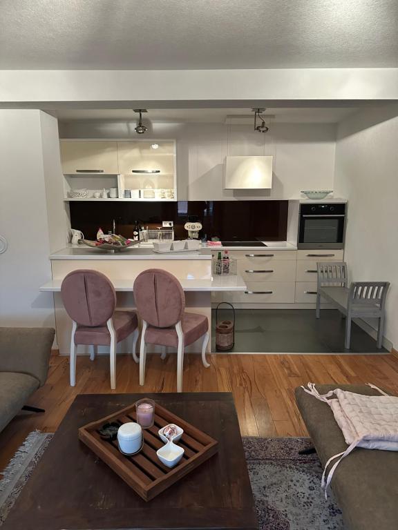 a kitchen and living room with a table and chairs at alisa in Srebrenik