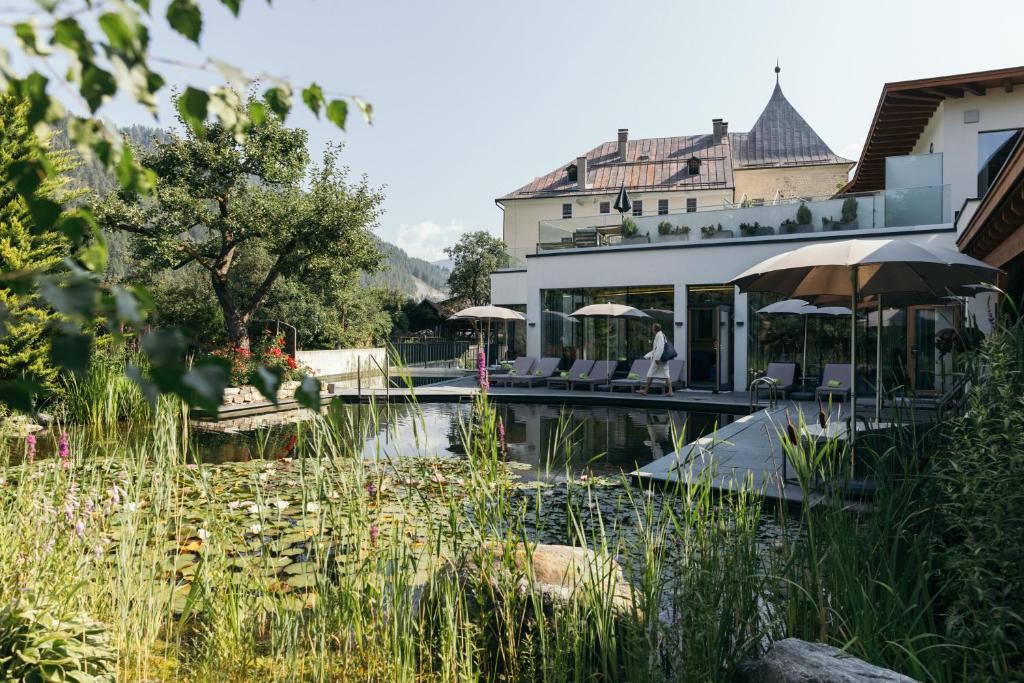 a house with a swimming pool and a building at Gartenhotel Linde 4 Sterne Superior in Ried im Oberinntal