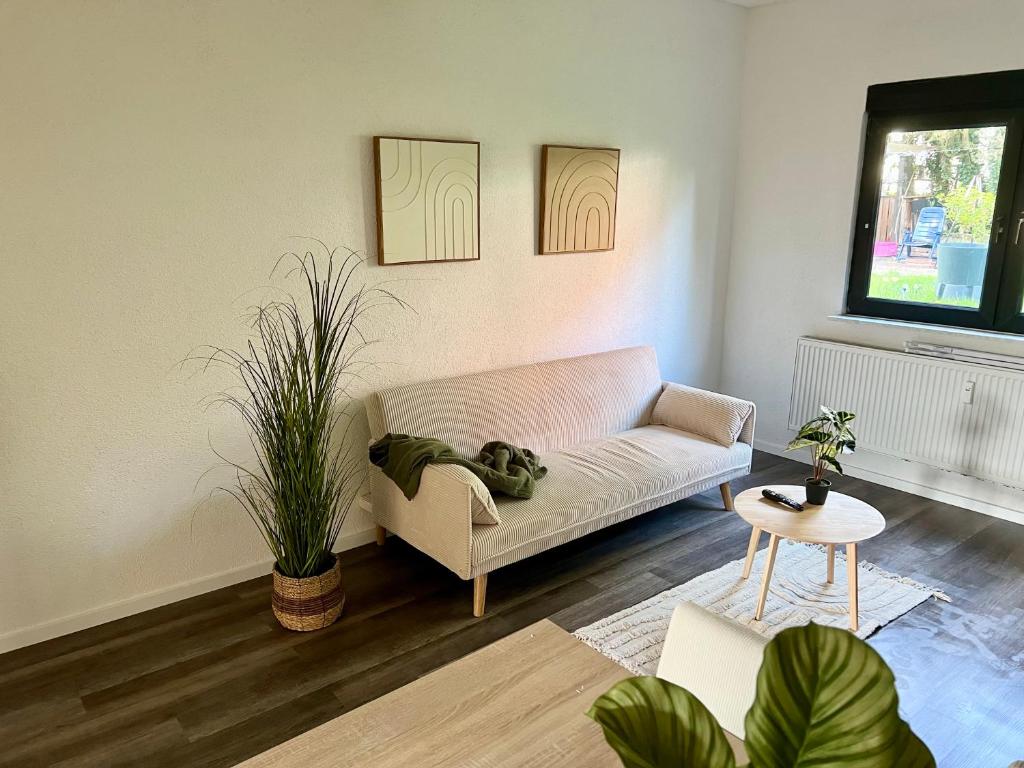 a living room with a couch and a table at Green Loft - Haus der Natur in Spiesen-Elversberg