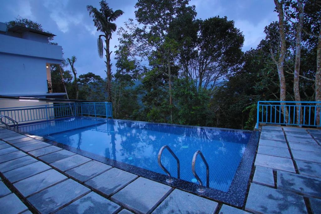 a swimming pool in the middle of a house at Nature Shade Pool Villa in Anachal