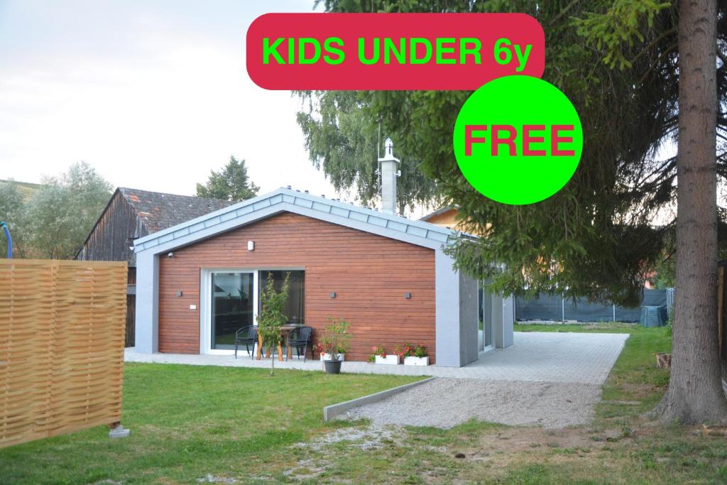a small house with a sign that reads kids under sly at Bungalov Vlnka in Vlachy