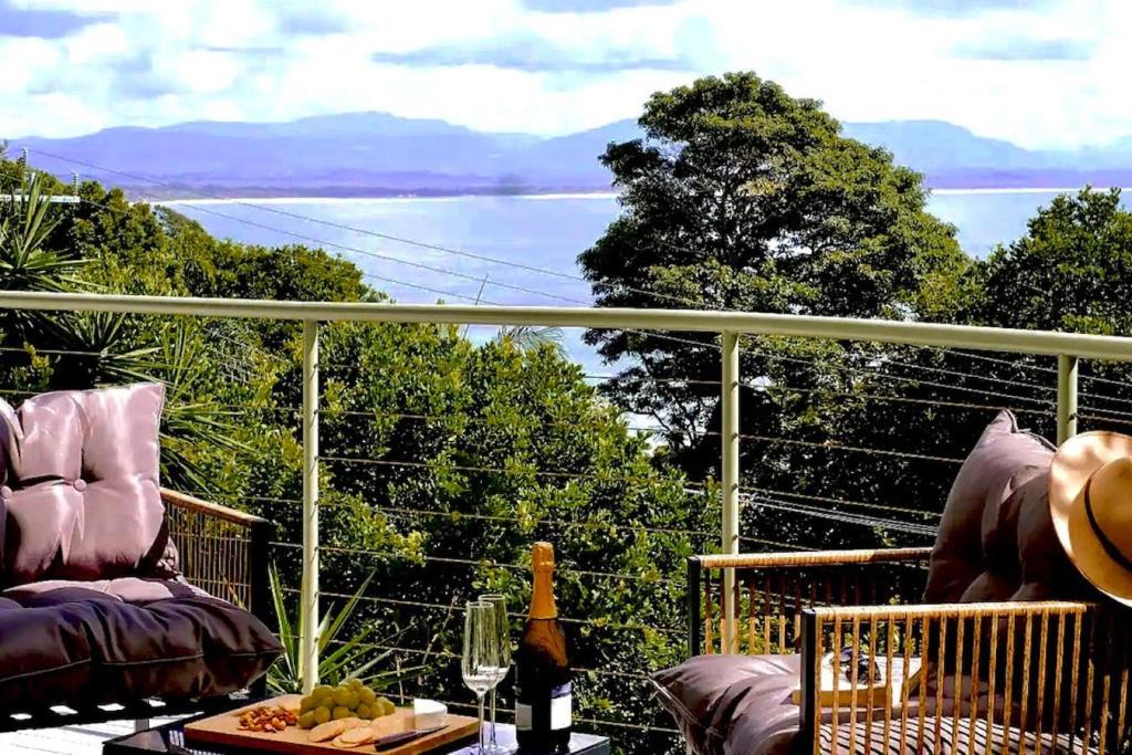 a balcony with a view of the water at Sanctuary Spaces - Wategoes Beach Shack in Byron Bay