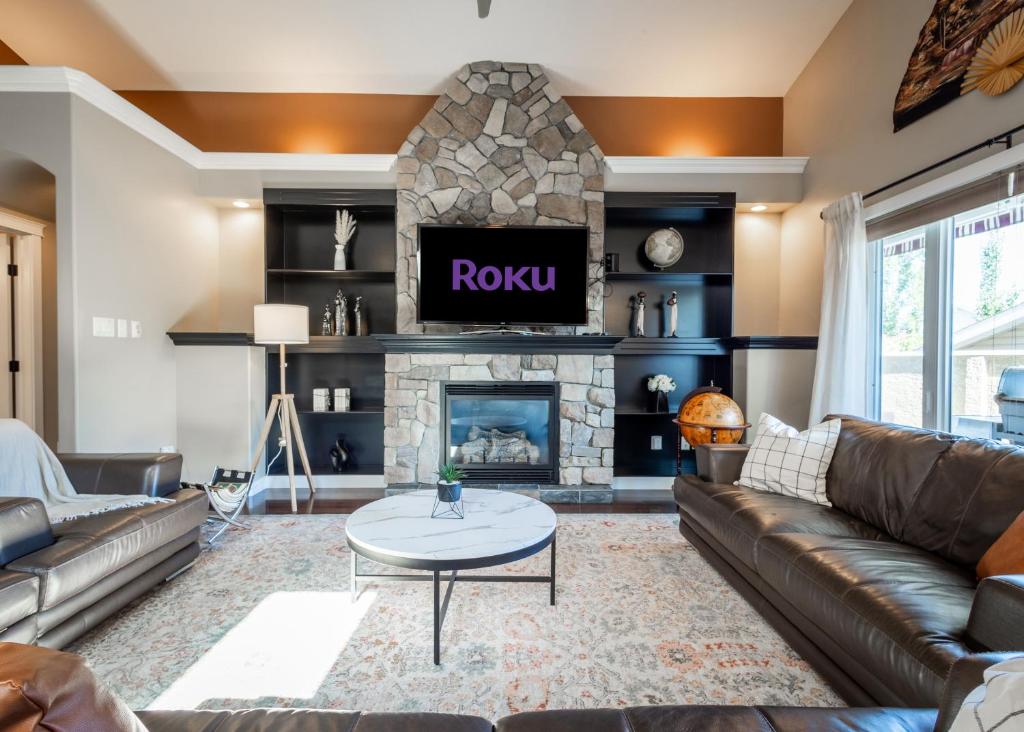 a living room with a couch and a fireplace at Modern comfort in Lethbridge