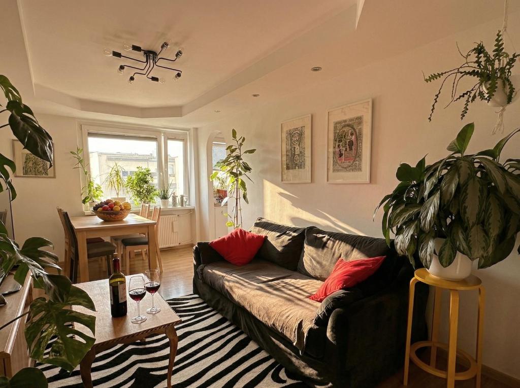 a living room with a couch and a table at ArtHaven Apartament Szwederowo in Bydgoszcz