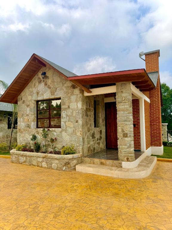 a small stone house with a porch at Royal Fest By GEstores in Huasca de Ocampo