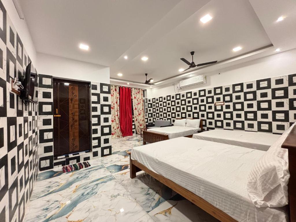 a bedroom with two beds in a room at Siva Lodge in Rāmeswaram