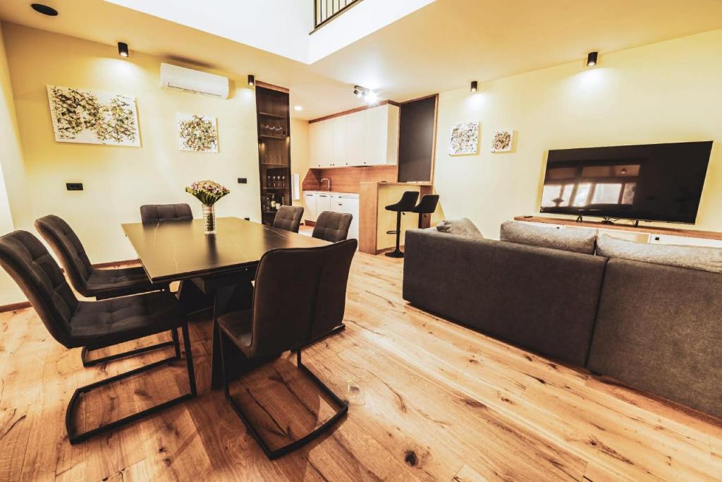 a living room with a table and a couch at Residence Legio XIII Gemina in Ptuj