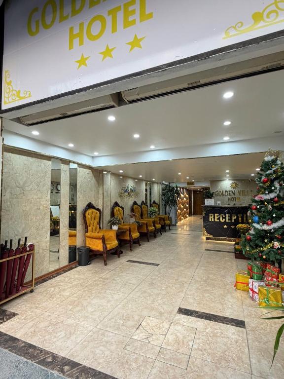 a christmas tree in the lobby of a hotel at Golden Villa in Hanoi