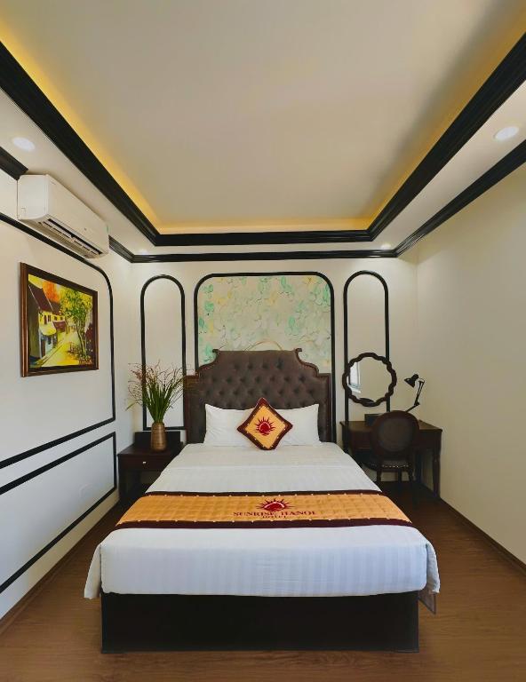 a bedroom with a large bed with a large window at Sunrise Villa Hanoi in Hanoi