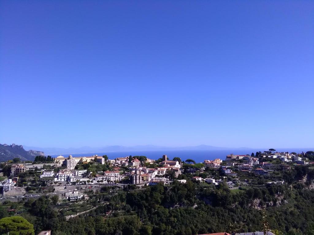 a city on a hill with the ocean in the background at Casa delle Campane in Scala