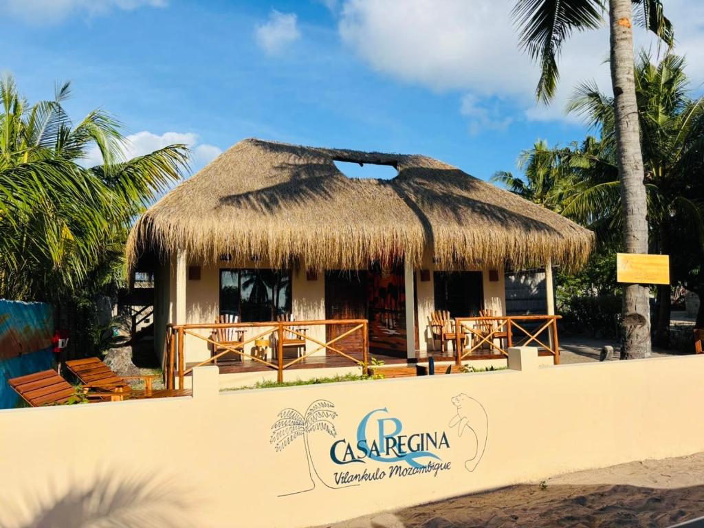a hut with a thatched roof on the beach at Casa Regina in Vilanculos
