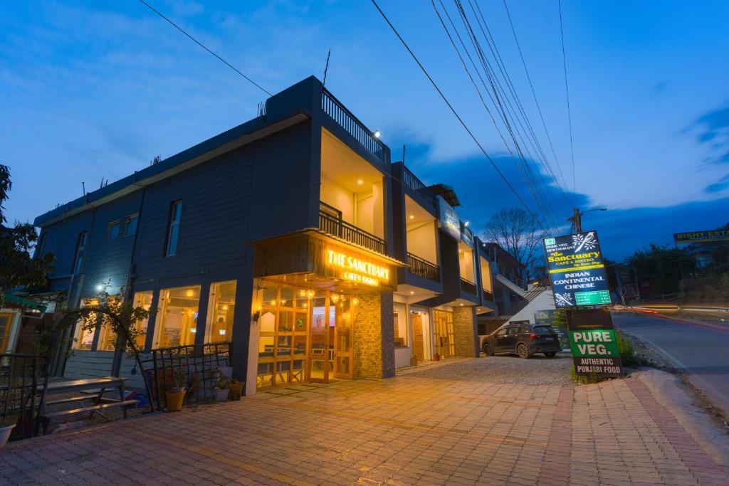 a building on the side of a street at night at Sanctuary Boutique Hotel in Bhīm Tāl