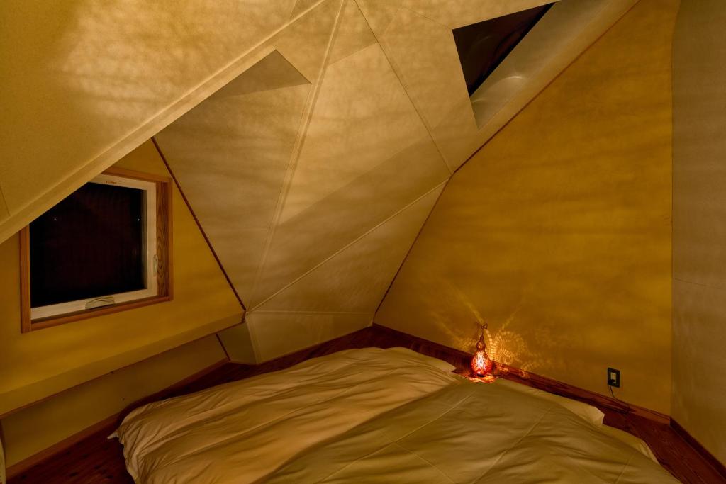Postel nebo postele na pokoji v ubytování Twin Dome Ryugu