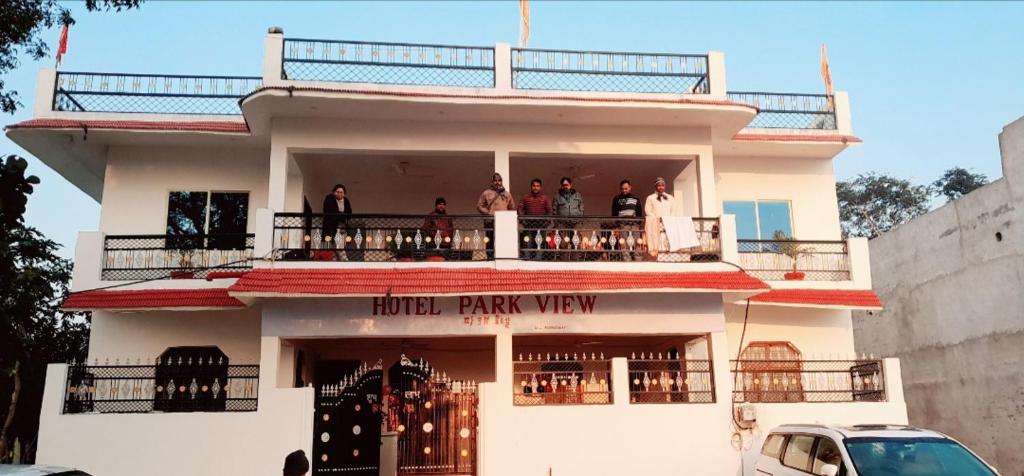 a group of people standing on the balcony of a building at Hotel Parkview in Khajurāho